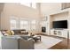 Spacious living room featuring a cozy fireplace, large windows, and comfortable seating at 10100 Isle St, Parker, CO 80134