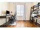 Bright home office featuring hardwood floors, a modern desk, and natural light at 10100 Isle St, Parker, CO 80134