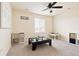 Spacious playroom features a dark-stained train table, ample natural light, and built-in storage at 10100 Isle St, Parker, CO 80134