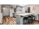 Basement bar area featuring gray cabinets, quartz countertop, wine storage, and bar stool seating at 15246 W 94Th Ave, Arvada, CO 80007