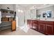 Bright bathroom featuring a walk-in shower, double vanity with cherry wood cabinets, and an organized storage area at 15246 W 94Th Ave, Arvada, CO 80007