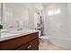 Well-lit bathroom featuring a vanity with a sink and a shower-tub combo at 15246 W 94Th Ave, Arvada, CO 80007