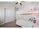 Upstairs bedroom with a bunk bed and closet at 15246 W 94Th Ave, Arvada, CO 80007