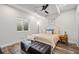 Bedroom with a wrought-iron bed frame, hardwood floors, and a large window that provides natural light at 15246 W 94Th Ave, Arvada, CO 80007