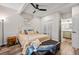 Bedroom with a wrought-iron bed frame, hardwood floors and access to an en-suite bathroom at 15246 W 94Th Ave, Arvada, CO 80007