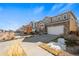 Attractive two-story home with stone accents, a two-car garage, and well-manicured front yard at 15246 W 94Th Ave, Arvada, CO 80007