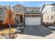 Charming two-story home featuring a stone facade and a well-maintained front yard at 15246 W 94Th Ave, Arvada, CO 80007