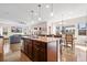 Open concept kitchen featuring a kitchen island, stainless steel appliances and modern lighting at 15246 W 94Th Ave, Arvada, CO 80007