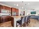 Modern kitchen featuring a granite-topped island with bar seating, stainless appliances, and rich wood cabinetry at 15246 W 94Th Ave, Arvada, CO 80007