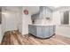 Basement kitchenette area with light gray cabinets, white countertops and wood-look floors at 15246 W 94Th Ave, Arvada, CO 80007