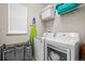 A bright laundry room complete with washer, dryer, shelving, and a folding rack at 15246 W 94Th Ave, Arvada, CO 80007