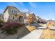 Street view of a two-story home with a stone and siding exterior, well-manicured lawn, and an attached garage at 15246 W 94Th Ave, Arvada, CO 80007