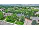 Aerial view of a house and surrounding neighborhood, showcasing landscaping and mountain views at 3351 Oak St, Wheat Ridge, CO 80033