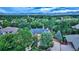 Aerial view of house nestled among trees with mountain backdrop at 3351 Oak St, Wheat Ridge, CO 80033