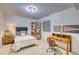 Bright bedroom with double bed, wood desk, and built-in shelving at 3351 Oak St, Wheat Ridge, CO 80033
