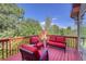 Relaxing deck with red couches and treetop views at 3351 Oak St, Wheat Ridge, CO 80033