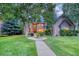 Brick two-story house with a landscaped lawn and walkway at 3351 Oak St, Wheat Ridge, CO 80033