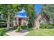 Brick house with landscaping and a walkway leading to the entrance at 3351 Oak St, Wheat Ridge, CO 80033