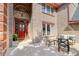 Inviting front entrance with a red door and small patio seating area at 3351 Oak St, Wheat Ridge, CO 80033