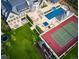 Aerial view showcases a sprawling estate featuring a sport court, pool, and playground at 4603 S Denice Dr, Cherry Hills Village, CO 80111