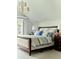 Charming bedroom featuring natural light, modern chandelier, and a queen bed at 4603 S Denice Dr, Cherry Hills Village, CO 80111