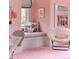 bedroom features a window seat with decorative pillows and soft pink walls at 4603 S Denice Dr, Cherry Hills Village, CO 80111