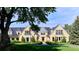 An estate with a sprawling lawn, beautiful stone architecture, and meticulous landscaping at 4603 S Denice Dr, Cherry Hills Village, CO 80111