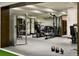 Spacious home gym featuring mirrored walls, weight machines, and workout equipment at 4603 S Denice Dr, Cherry Hills Village, CO 80111