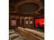 Comfortable home theater room with tiered seating and a large projection screen at 4603 S Denice Dr, Cherry Hills Village, CO 80111