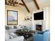 Inviting living room with a cozy fireplace and a mounted television at 4603 S Denice Dr, Cherry Hills Village, CO 80111