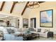 Spacious living room featuring vaulted ceilings, exposed beams, and ample seating at 4603 S Denice Dr, Cherry Hills Village, CO 80111