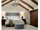 Cozy primary bedroom with beautiful vaulted ceilings and decorative wooden beams at 4603 S Denice Dr, Cherry Hills Village, CO 80111