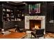 Cozy office space with a marble fireplace and built-in shelving at 4603 S Denice Dr, Cherry Hills Village, CO 80111
