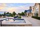 Backyard swimming pool with sun loungers and nearby patio, as well as a beautiful sunset at 4603 S Denice Dr, Cherry Hills Village, CO 80111