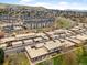 An aerial shot shows a residential neighborhood with well-maintained townhomes and green spaces at 12979 W Ohio Ave, Lakewood, CO 80228