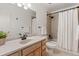 Traditional bathroom with a vanity, bath tub with curtain, and decorative accents at 12979 W Ohio Ave, Lakewood, CO 80228