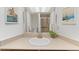 Bright bathroom with neutral countertops, framed art, and large mirror reflecting the shower at 12979 W Ohio Ave, Lakewood, CO 80228