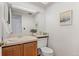 Bathroom featuring a vanity with wood cabinets, white countertop, and a framed mirror at 12979 W Ohio Ave, Lakewood, CO 80228