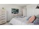 Neutral bedroom features a modern dresser, TV, and comfortable bedding with closet at 12979 W Ohio Ave, Lakewood, CO 80228