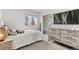 Cozy bedroom featuring a plush bed, modern dresser, and ample natural light from the window at 12979 W Ohio Ave, Lakewood, CO 80228