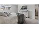 Bedroom featuring a dresser with a mounted television and a comfortable bed at 12979 W Ohio Ave, Lakewood, CO 80228