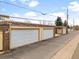Row of detached garages, each with a metal overhead door, in a community with well-maintained grounds at 12979 W Ohio Ave, Lakewood, CO 80228