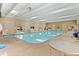 Bright indoor pool area with clear water and ample seating, perfect for year-round enjoyment and relaxation at 12979 W Ohio Ave, Lakewood, CO 80228