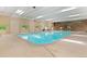 Spacious indoor pool featuring clear water, skylights, and a stone accent wall, creating a relaxing atmosphere at 12979 W Ohio Ave, Lakewood, CO 80228
