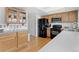 Spacious kitchen with wood cabinets and modern stainless steel appliances at 12979 W Ohio Ave, Lakewood, CO 80228