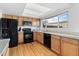 Bright kitchen featuring stainless steel appliances, wood cabinets, and modern lighting at 12979 W Ohio Ave, Lakewood, CO 80228