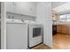 Well-lit laundry room equipped with a modern washer and dryer at 12979 W Ohio Ave, Lakewood, CO 80228
