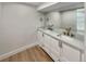 Elegant bathroom featuring a double vanity, quartz countertops, and modern fixtures at 6650 Depew Ct, Arvada, CO 80003