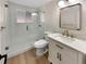 Stylish bathroom featuring a glass-enclosed shower and a vanity with modern fixtures at 6650 Depew Ct, Arvada, CO 80003