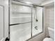 Relaxing bathtub and shower combo with sliding glass doors at 6650 Depew Ct, Arvada, CO 80003